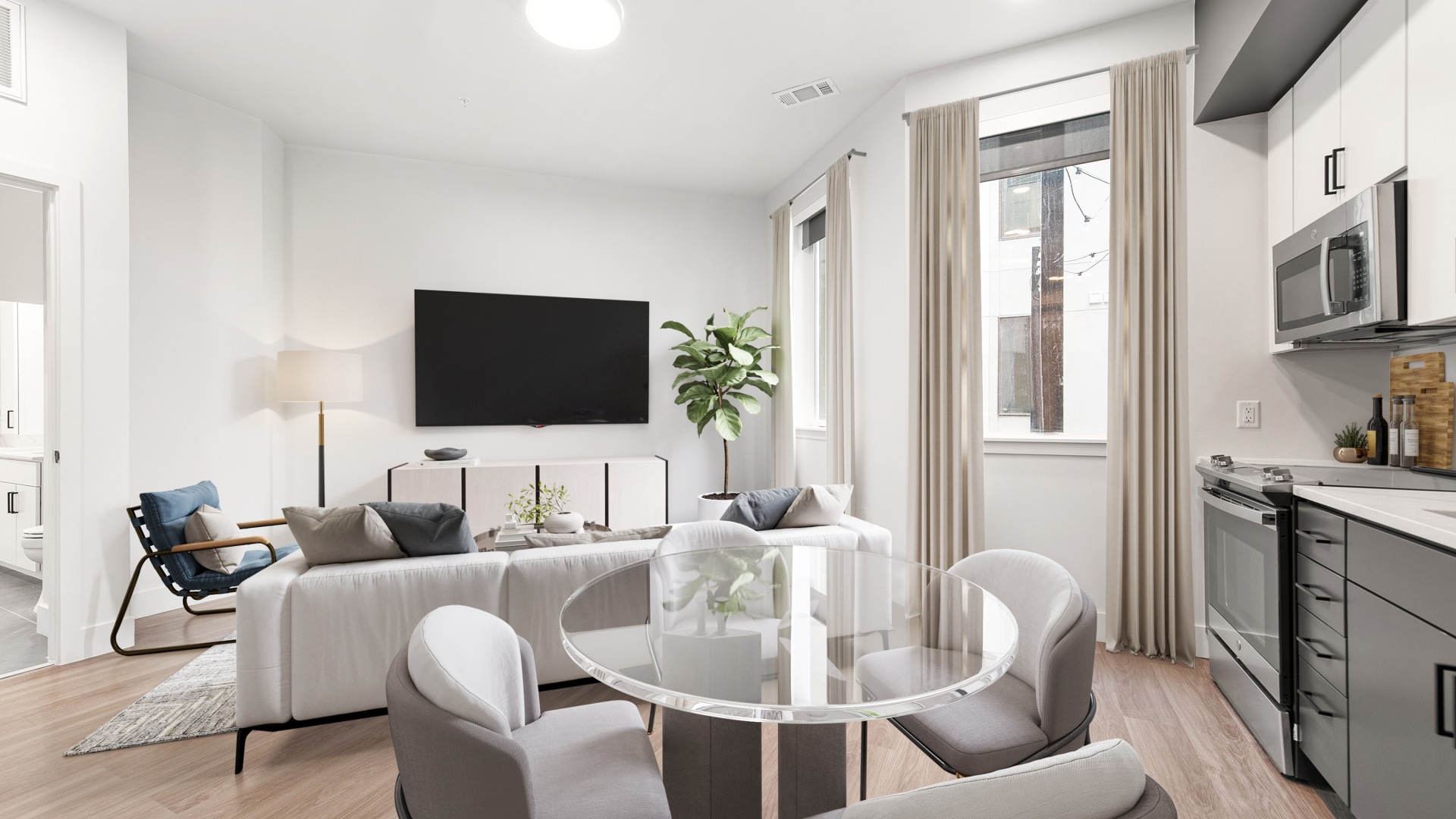 dining room table with windows and curtains with living room 