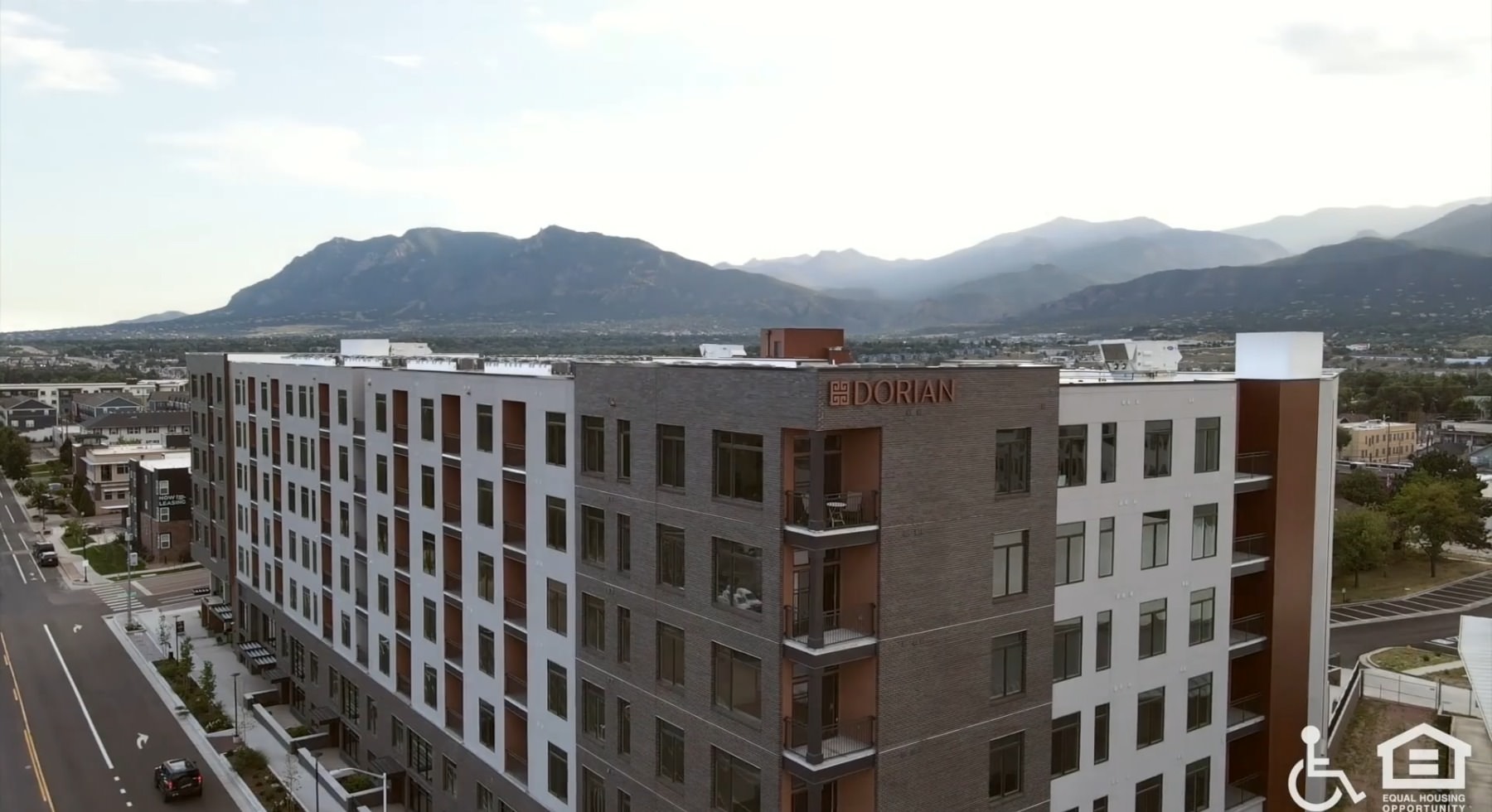 aerial view of a multi-story building with mountains in the background