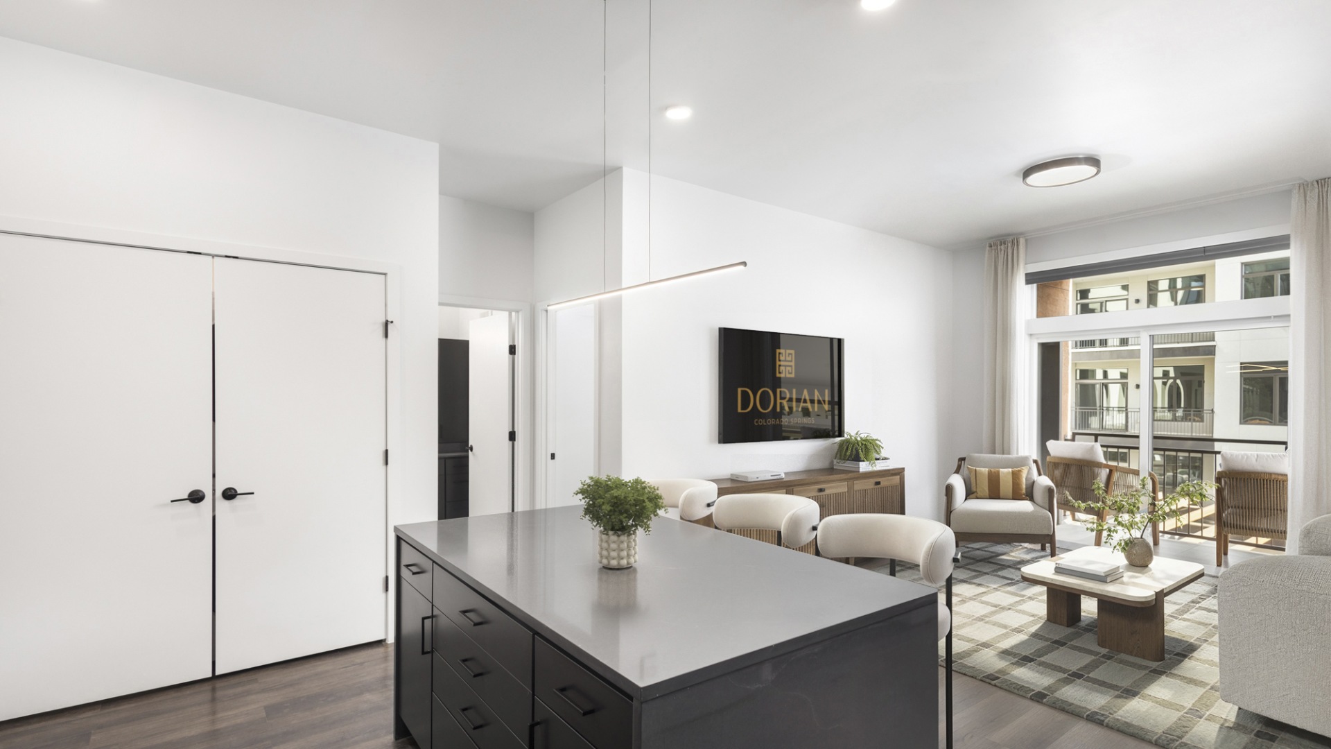 Spacious modern apartment with sleek kitchen island, stylish living room, and large windows for natural light.	